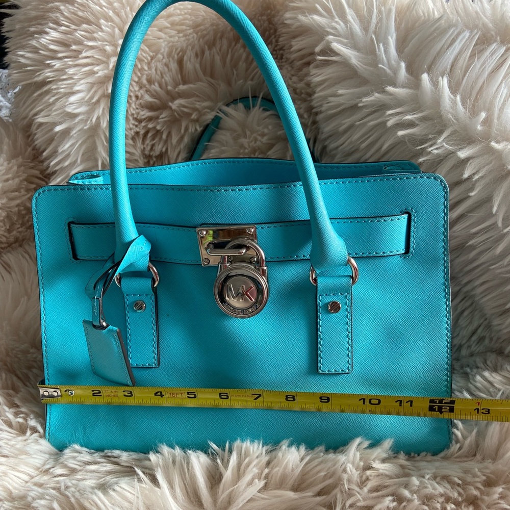 A beautiful turquoise with silver hardware Michael Kors purse.